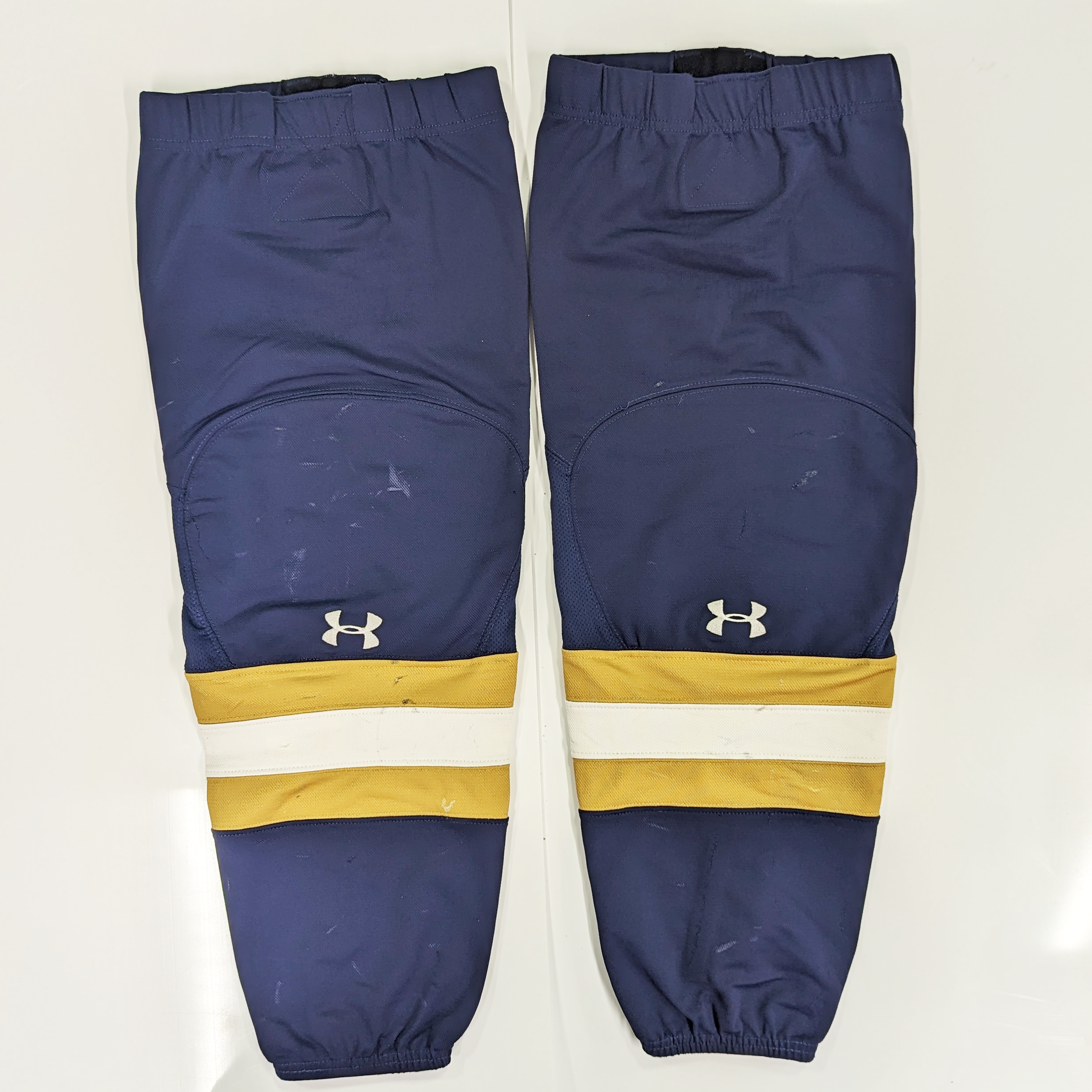 NCAA - Chaussettes de hockey Under Armour d'occasion (bleu marine/doré/blanc)
